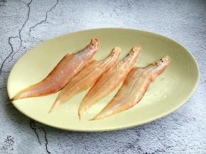 将小比目鱼的一面刮鳞，一面去皮，去除内脏和头，清洗干净，沥干水分备用。