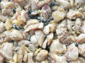 鸡球遇热自然收缩变“球状”，翻炒至完全变色。