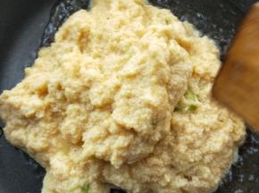 起油锅，烧热，倒入搅拌好的豆渣。