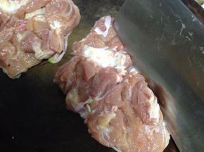 用刀背轻剁鸡（目的可以使鸡肉松软、进味）
