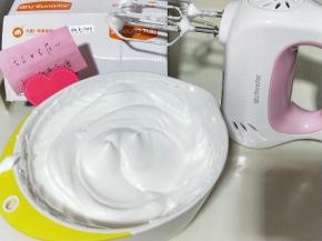 电动打蛋器高速打发，打至湿性发泡时加入最后的三分之一糖粉，，继续打发至蛋白出现细腻的纹路，将电动打蛋器调低速打发一会儿，感觉有些阻力时，就可以停止打发，以免消泡，提起打蛋器有微微的弯勾就可以，如图