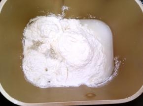 将面粉加水，用面包机和成面团，手揉面团要将面团揉至表面光滑状态