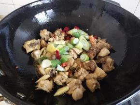 炒到鸡肉微黄加入葱姜辣椒继续煸炒