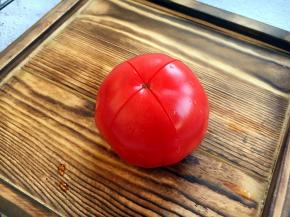 番茄清洗干净，在顶部划一个十字。