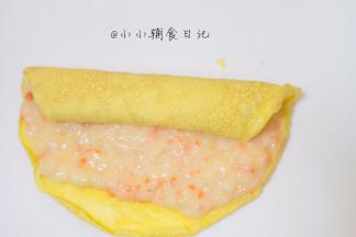 将蛋皮摊开均匀的抹上一层虾泥，靠近身体的地方留出一点不要抹，因为卷起来的时候虾泥会自动带蛋皮边缘来
