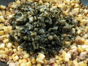 倒入焙干的腌菜。
