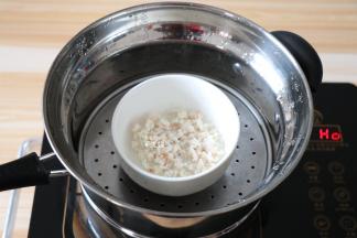 腌制好的磷虾肉上锅蒸5分钟左右，然后倒掉碗里多余水分；