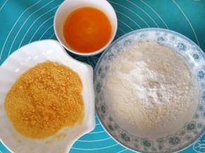鸡蛋打散，倒适量的面粉和面包糠在碗里