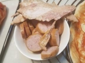 脆皮肠切片待用，培根切丝。