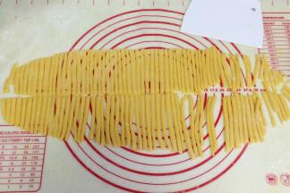 擀开之后，用刮刀切成长度为3～5毫米，宽度为5毫米的面条状。