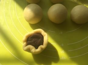 之后包好豆沙馅，捏紧收口，收口朝下放