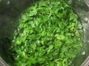烧一锅开水，将艾叶在热水中焯几秒。