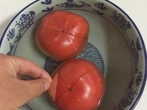 西红柿划十字刀，用开水烫一下，就可以轻松的剥掉西红柿的皮啦！