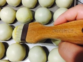 刷上全蛋液！「推荐学厨毛刷，如果用硅胶刷太硬会破坏蛋黄酥表面，坑坑洼洼，影响美观，」