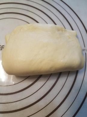 再把黄油片和面片一起翻折上去，接口处压紧，这样就完成了黄油片的裹入。同时这种裹入法相当于做了一次2折。