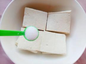 切好的豆腐装碗加入一勺盐