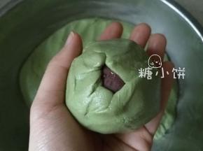 用手将糯米皮沿着馅料往上推，慢慢推至收口处