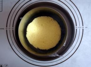 6寸的加高慕斯圈底部包上一层保鲜模或锡纸，将模具放在碟子上，放入一片蛋糕片。