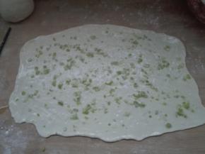 发酵好的面团擀成大片，抹层油，撒适量盐，撒葱沫
