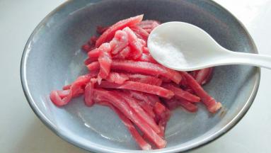 准备大碗，放入肉丝，盐2克，胡椒粉1小撮，葡萄酒2茶匙。