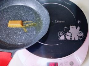 起油锅，油温6成时加入咖喱块，将其炒至融化。如图