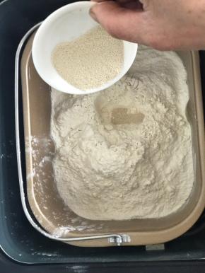 再加入再加入面粉，在面粉中间挖个小窝，倒入酵母，启动搅拌功能进行揉面20分钟