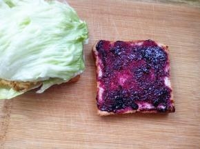 另一片面包片抹上蓝莓酱；