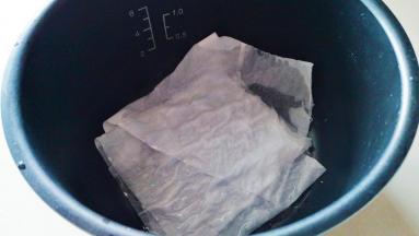 电饭煲内胆中放入几张纸，用适量清水打湿。