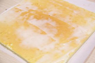 把蛋糕平铺在油纸上，蛋糕表层涂抹一层薄薄的沙拉酱哦~(防止紫菜脱落)