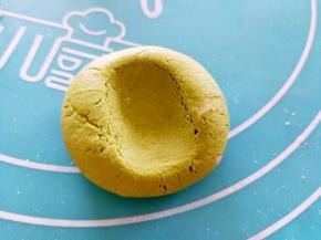 取一份面团搓圆，中间用手轻轻按一下