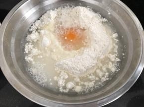 接下来做饼皮了
面粉倒大碗中，加入一个鸡蛋（可以自选要不要）加入适量清水，不确定水量的慢慢加哈