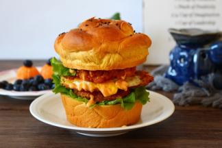 中间切开，底部抹一层薄薄的沙拉酱，依次放入生菜，鸡柳，煎蛋，鸡柳，生菜，沙拉酱