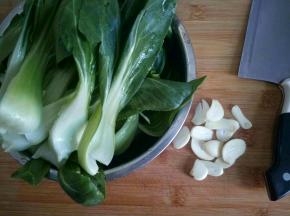 青菜从中间切开，方便快熟和入味，蒜切片。