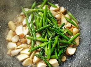 待杏鲍菇熟，转大火倒入芦笋。