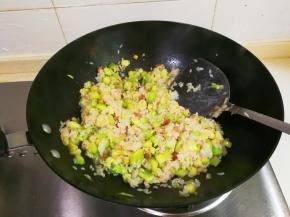 放入大米翻炒至水分完全被大米吸收，米香味漂出