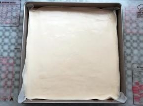 蛋糕糊倒入铺了油纸的烤盘里，轻震2下烤盘，去掉蛋糕糊里的气泡