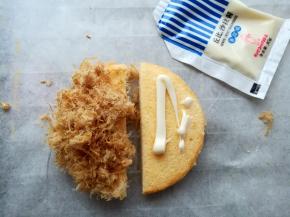 在蛋糕的底部涂上适量的沙拉酱，一边放上肉松