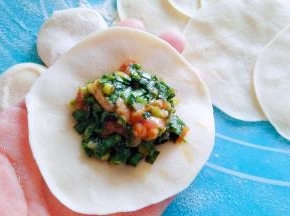 取一个饺子皮中间放陷。