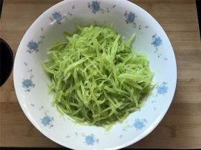 把刨好的莴笋擦成丝。