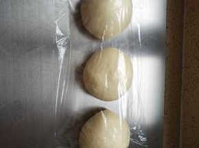 按压排气平均分成三等份，盖保鲜膜松弛15分钟