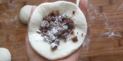 取一个擀好的面片放入适量的红糖和一点面粉