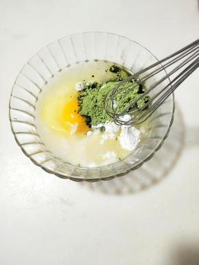 将一份鸡蛋仔预拌粉放在碗里，放入鸡蛋和植物油，加入青汁粉、
面糊调好之后静止备用。