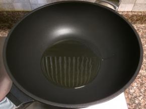 热锅倒油烧至八成热。