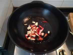 热锅放油，放入蒜片和小米辣煸香