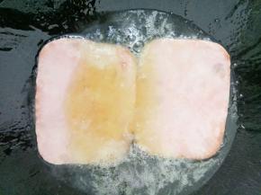 锅里热油放入午餐肉煎熟