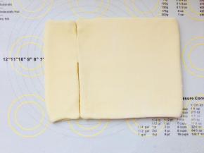 掀起左边顶端向右折叠到四分之一处。掀起右侧顶端向左折叠到四分之三处。两端收口相遇。