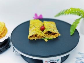 把放上脆饼的煎饼卷起来，卷好后再从中间切开即可食用。