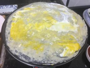 接着加入鸡蛋，用铲刀摊匀。