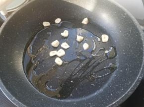 蒜瓣切片，加入锅内炒香。