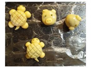 皮包好馅料后捏出动物的形状，用牙签压出纹饰，用绿豆、红豆或芝麻做眼睛
